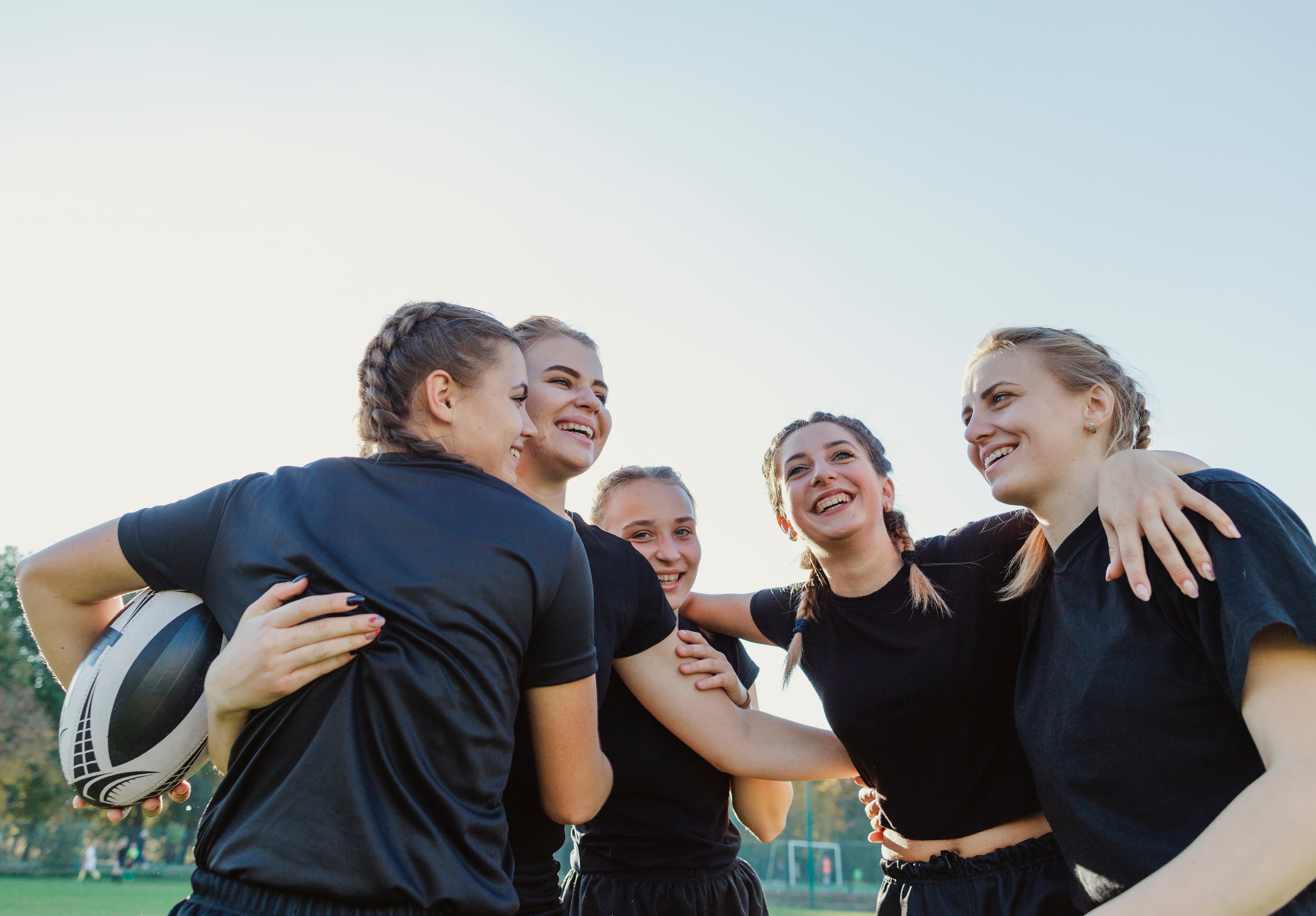 Sportive women embracing each other